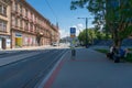 Pilsen street with tramway stop with public transport timetable and people