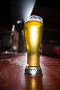 Pilsner beer glass on a table Royalty Free Stock Photo