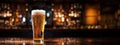 Pilsner glass of light beer on bar table in a dark pub with copy space. Generative AI Royalty Free Stock Photo