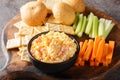 Pimento cheese with celery, carrot sticks and crackers closeup on the wooden board. Horizontal Royalty Free Stock Photo