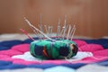 Pin cushion on a colorful mosaic hexagon patterned quilt