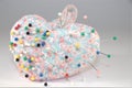 Pin cushion with pins on white Royalty Free Stock Photo