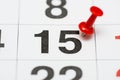 Pin on the date number 15. The fifteenth day of the month is marked with a red thumbtack. Pin on calendar Royalty Free Stock Photo