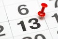 Pin on the date number 13. The thirteen day of the month is marked with a red thumbtack. Pin on calendar Royalty Free Stock Photo