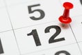 Pin on the date number 12. The twelfth day of the month is marked with a red thumbtack. Pin on calendar Royalty Free Stock Photo