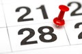 Pin on the date number 28. The twenty eighth day of the month is marked with a red thumbtack. Pin on calendar Royalty Free Stock Photo