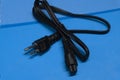 3 pin power cord on dark turquoise background. power plug. Royalty Free Stock Photo