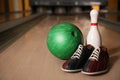 Pin, shoes and ball on alley in bowling club Royalty Free Stock Photo