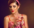 Pin up girl drink bloody Mary cocktail. Pin-up retro female style. Royalty Free Stock Photo