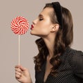 Pin-up girl holding big red lollipop in hand Royalty Free Stock Photo