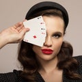 Pin-up girl holding a four aces. Retro fashion portrait Royalty Free Stock Photo