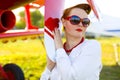 Pin-up girl and red plane