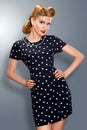 Pin-up girl in retro vintage dress posing