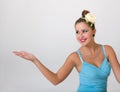 Pin-up girl showing something on palm of hand Royalty Free Stock Photo