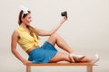 Pin up girl woman taking selfie photo with camera. Royalty Free Stock Photo