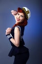 Pin up model in sailor costume isolated on blue background