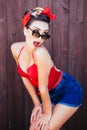 Pin-up pose with wood dressing room background