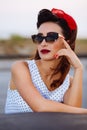 Pin-up poses with vintage sunglasses