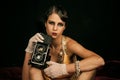 Pin up pretty fashion model photographer. Girl with vintage photo camera. Royalty Free Stock Photo