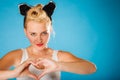 Pin up style, retro girl with heart sign. Royalty Free Stock Photo