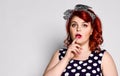 Pin up redhead woman. Beautiful retro female in polka dot dress with red lips and manicure nails and old fashion hairstyle