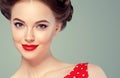 Pin up woman portrait. Beautiful retro female in polka dot dress with red lips and manicure nails and old fshion hairstyle hand Royalty Free Stock Photo