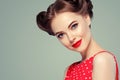 Pin up woman portrait. Beautiful retro female in polka dot dress with red lips and old fshion hairstyle Royalty Free Stock Photo