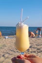 Pina-colada cocktail on the beach in woman hand Royalty Free Stock Photo