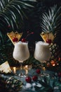 Pina colada cocktails garnished with pineapple wedges and cherries. Studio photography with tropical bar concept. Design for menu
