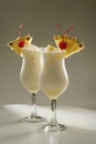 Pina Colada cocktails with pineapple and cherry garnish