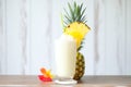 pina colada in hurricane glass, pineapple wedge