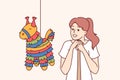 Pinata with candy near girl with bat, preparing to smash horse-shaped toy for birthday parties Royalty Free Stock Photo