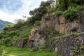 Pinchinuyok ancient Inca ruins surrounded by mountain peaks and clouds above the green canyon in Peru Royalty Free Stock Photo