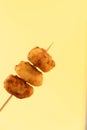 Pincho of home-made croquettes of ham, typical Spanish dish on yellow background Royalty Free Stock Photo