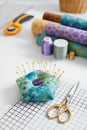 Pincushion, craft mat, scissors, fabric rolls, sewing and quilting accessories Royalty Free Stock Photo