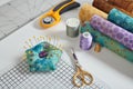 Pincushion, craft mat, scissors, rotary cutter, fabric rolls, sewing and quilting accessories