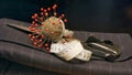 Pincushion, an old scissors and a measuring tape on gray flanel fabric Royalty Free Stock Photo