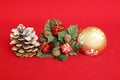 pine apple with snow, red gifts and a golden ball on a red background for holiday decoration Royalty Free Stock Photo