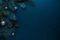 Pine branch with cone and decorative silver ornaments on minimal dark blue Christmas banner background