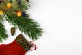 pine branch with a lit Christmas tree garland pine cone stocking Santa claus on a white background Royalty Free Stock Photo