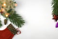 pine branch with a lit Christmas tree garland pine cone stocking Santa claus on a white background Royalty Free Stock Photo