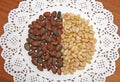 Pine brown and yellow nuts are laid out on a white napkin. Brown, beige, white, contrast. Royalty Free Stock Photo