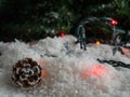 Pine cone on decorative snow under a Christmas tree Royalty Free Stock Photo