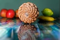 pine cone with spirals on reflecting table