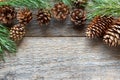 Pine cones and branches on wooden background Christmas background Copy space selective focus. Royalty Free Stock Photo