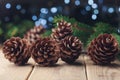 Pine cones and fir tree branch on rustic wooden table. Christmas greeting card. Royalty Free Stock Photo