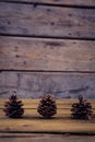 Pine cones on wooden plank Royalty Free Stock Photo