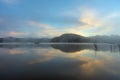 Pine forest island and shrubs refection on the lake at dawn with magic of the sky and clouds part 3 Royalty Free Stock Photo