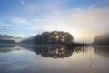 Pine forest island and shrubs refection on the lake at dawn with magic of the sky and clouds part 7 Royalty Free Stock Photo