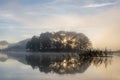 Pine forest island and shrubs refection on the lake at dawn with magic of the sky and clouds part 8 Royalty Free Stock Photo